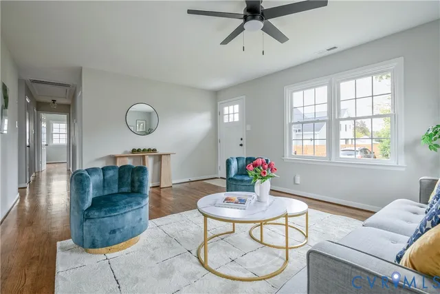 a living room with furniture a fireplace and a window