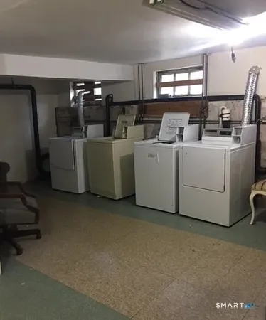 a view of a storage & utility room with two washing machine
