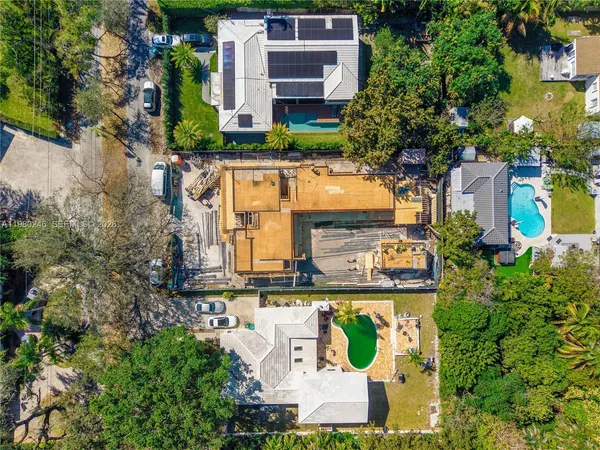 an aerial view of a house with a garden and trees