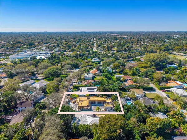 an aerial view of a residential houses with city view