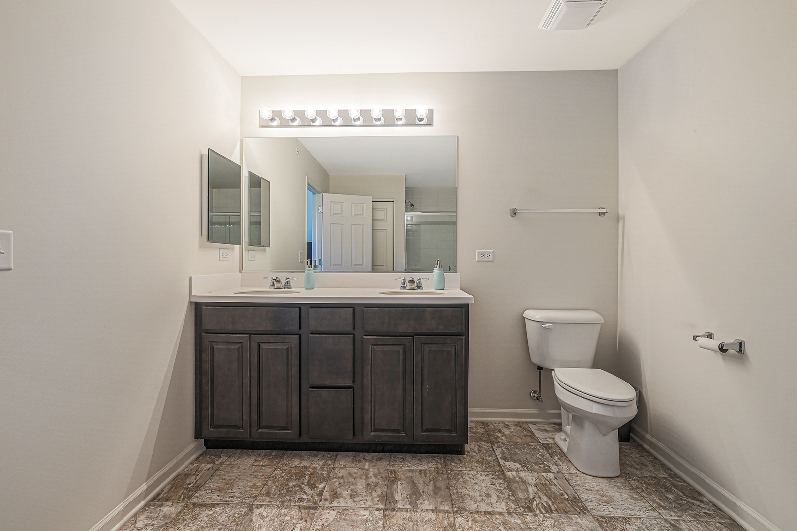 5835 Fairview Lane Hoffman Estates, IL 60192 - Photo 22 of 33 a bathroom with a toilet a sink and mirror