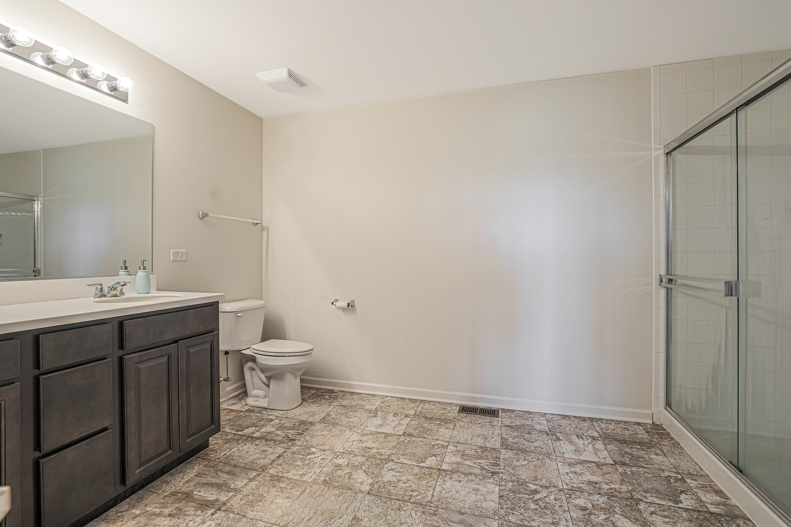 5835 Fairview Lane Hoffman Estates, IL 60192 - Photo 23 of 33 a bathroom with a toilet sink and a mirror