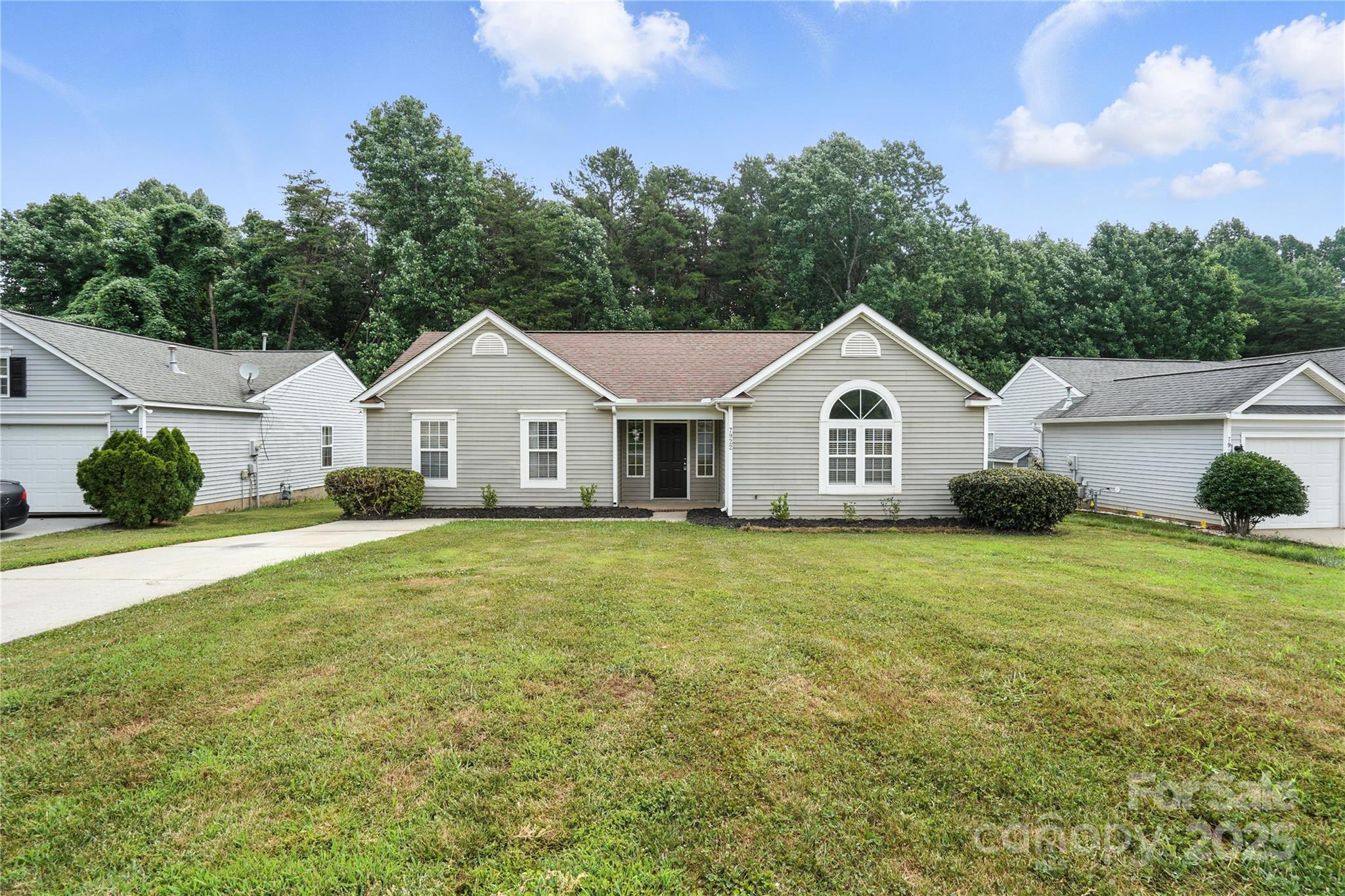 7922 Travers Run Drive Charlotte, NC 28215 - Photo 2 of 31 a view of a white house with a yard and large trees