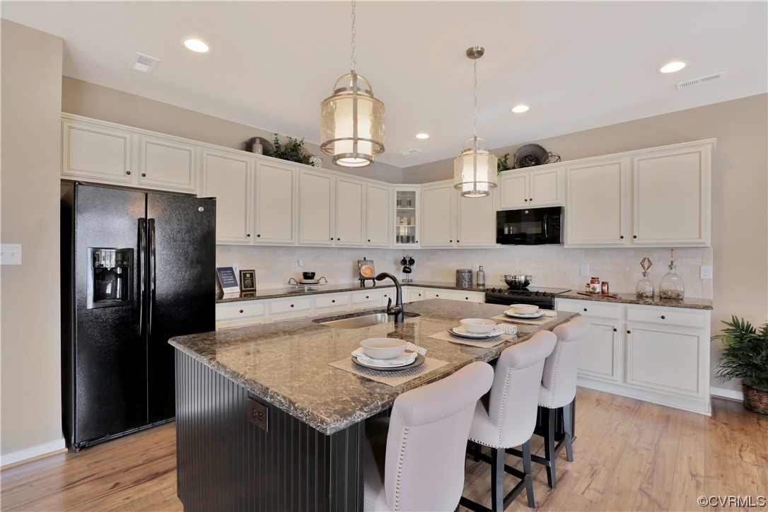12918 Deep Wl Road Midlothian, VA 23112 - Photo 8 of 50 a kitchen with kitchen island granite countertop a sink a center island stainless steel appliances and cabinets