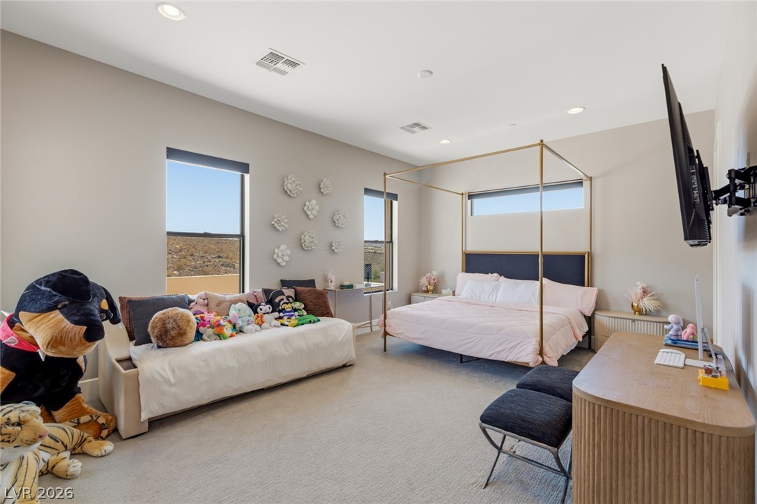 5 Crystal Tree Pass Henderson, NV 89052 - Photo 31 of 67 Recessed lighting illuminates this inviting bedroom, featuring carpeted flooring and large windows with scenic desert views.