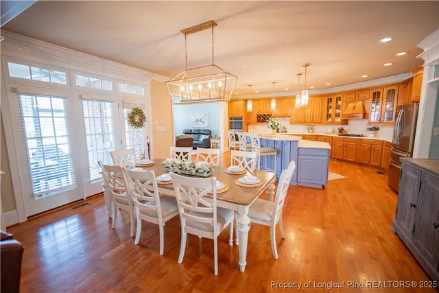 a view of a dining room with furniture large windows and wooden floor