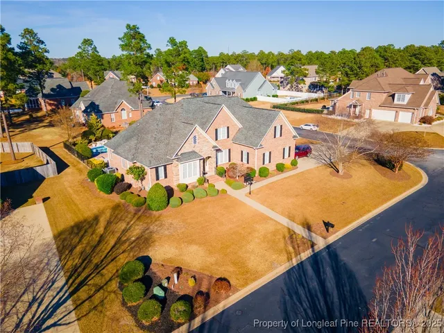 an aerial view of residential houses with outdoor space and seating area