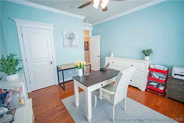 a view of a workspace with furniture and wooden floor