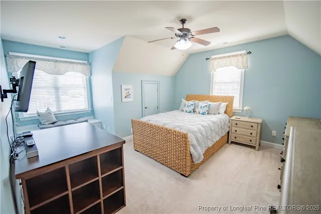 a bedroom with a large bed and window