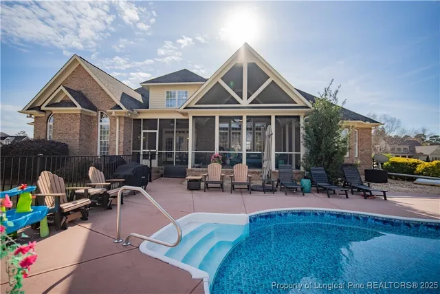 a group of people sitting in front of house