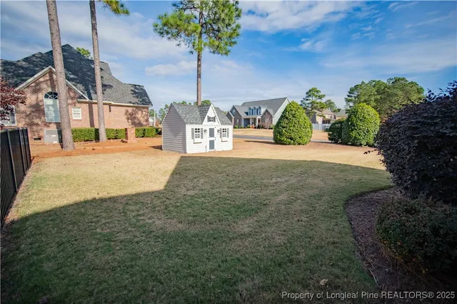 a view of a house with a yard and potted plants