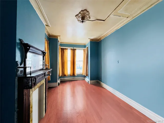 a view of a livingroom with wooden floor and a window