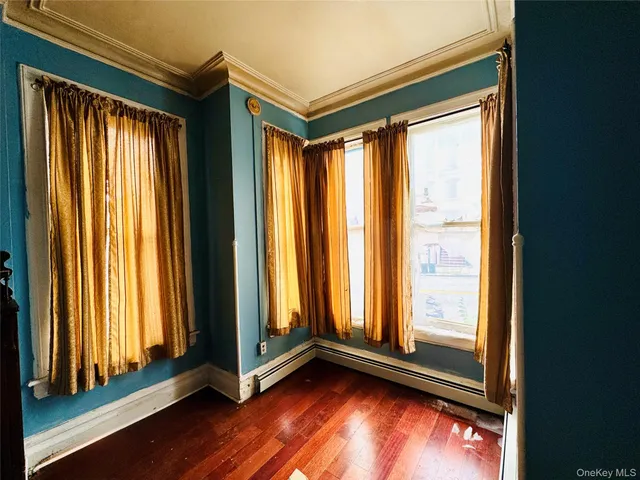 a view of an empty room and wooden floor