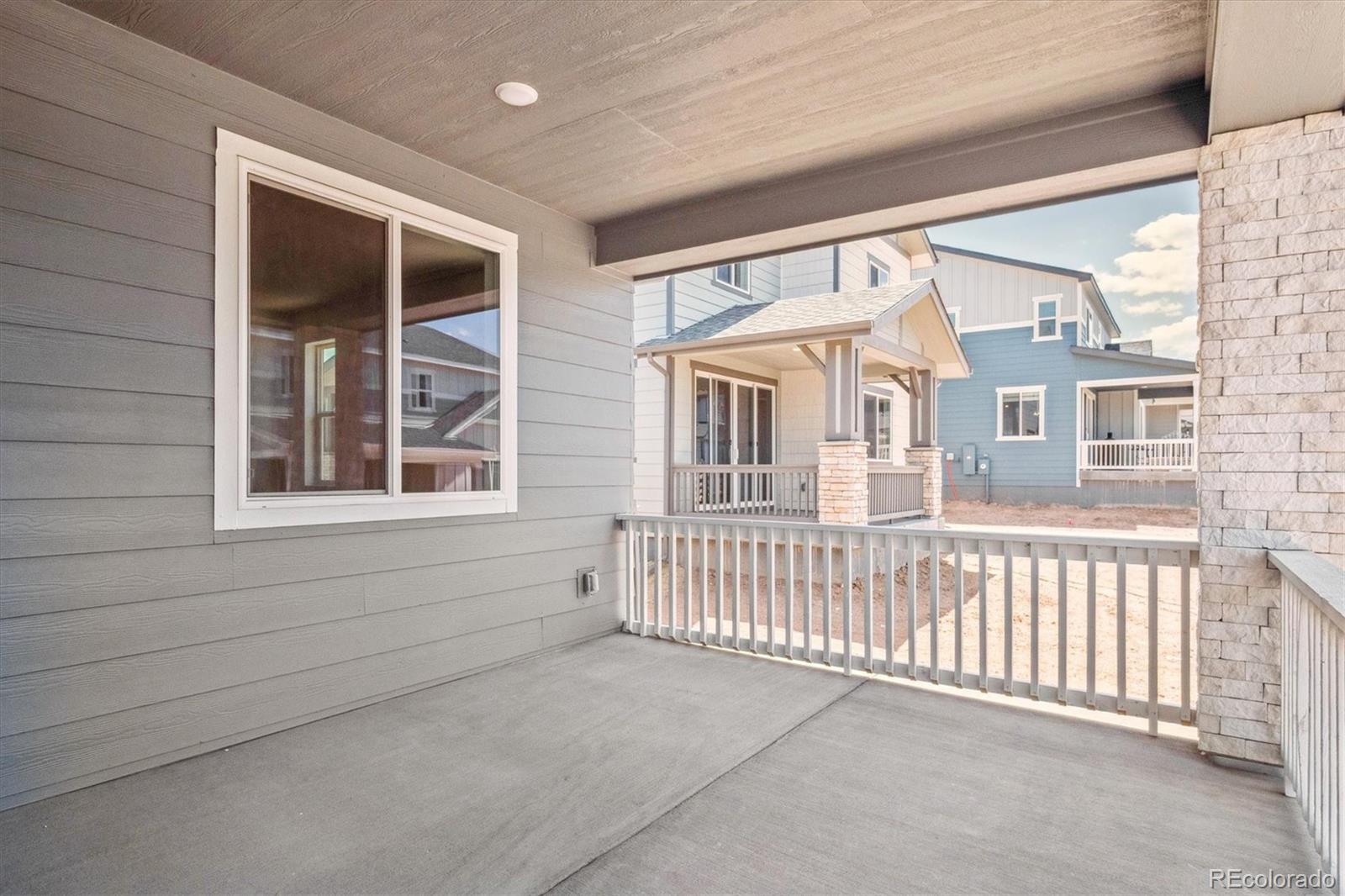 8317 Eagle River Street Littleton, CO 80125 - Photo 16 of 18 a view of a house with a porch