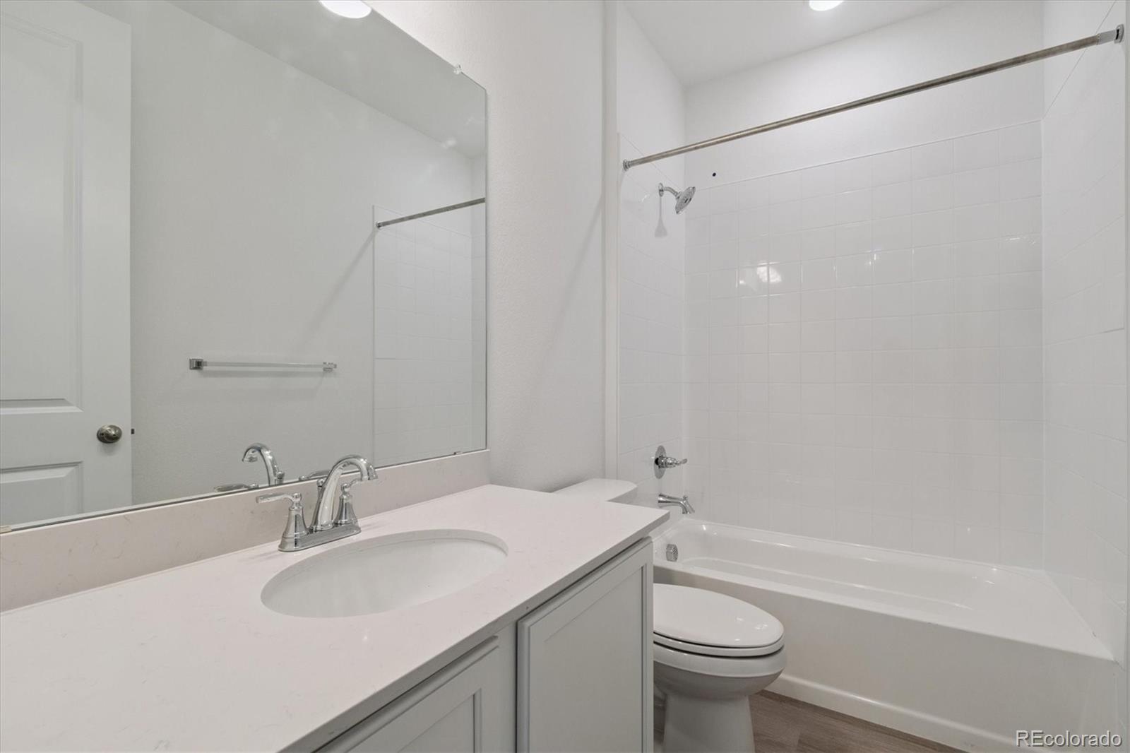 8317 Eagle River Street Littleton, CO 80125 - Photo 3 of 18 a bathroom with a sink toilet and shower