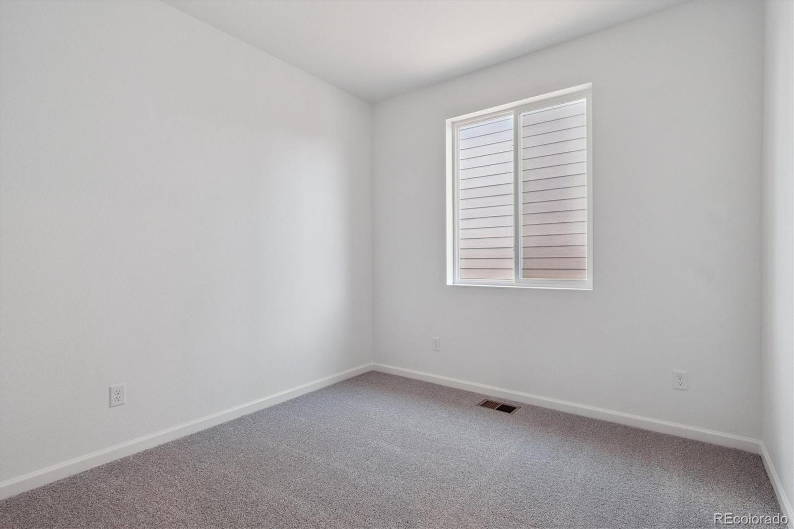 8317 Eagle River Street Littleton, CO 80125 - Photo 4 of 18 an empty room with a window