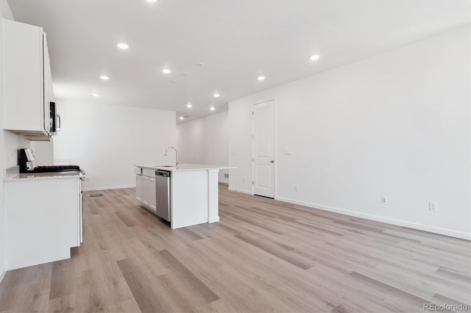 8317 Eagle River Street Littleton, CO 80125 - Photo 6 of 18 a view of kitchen with wooden floor