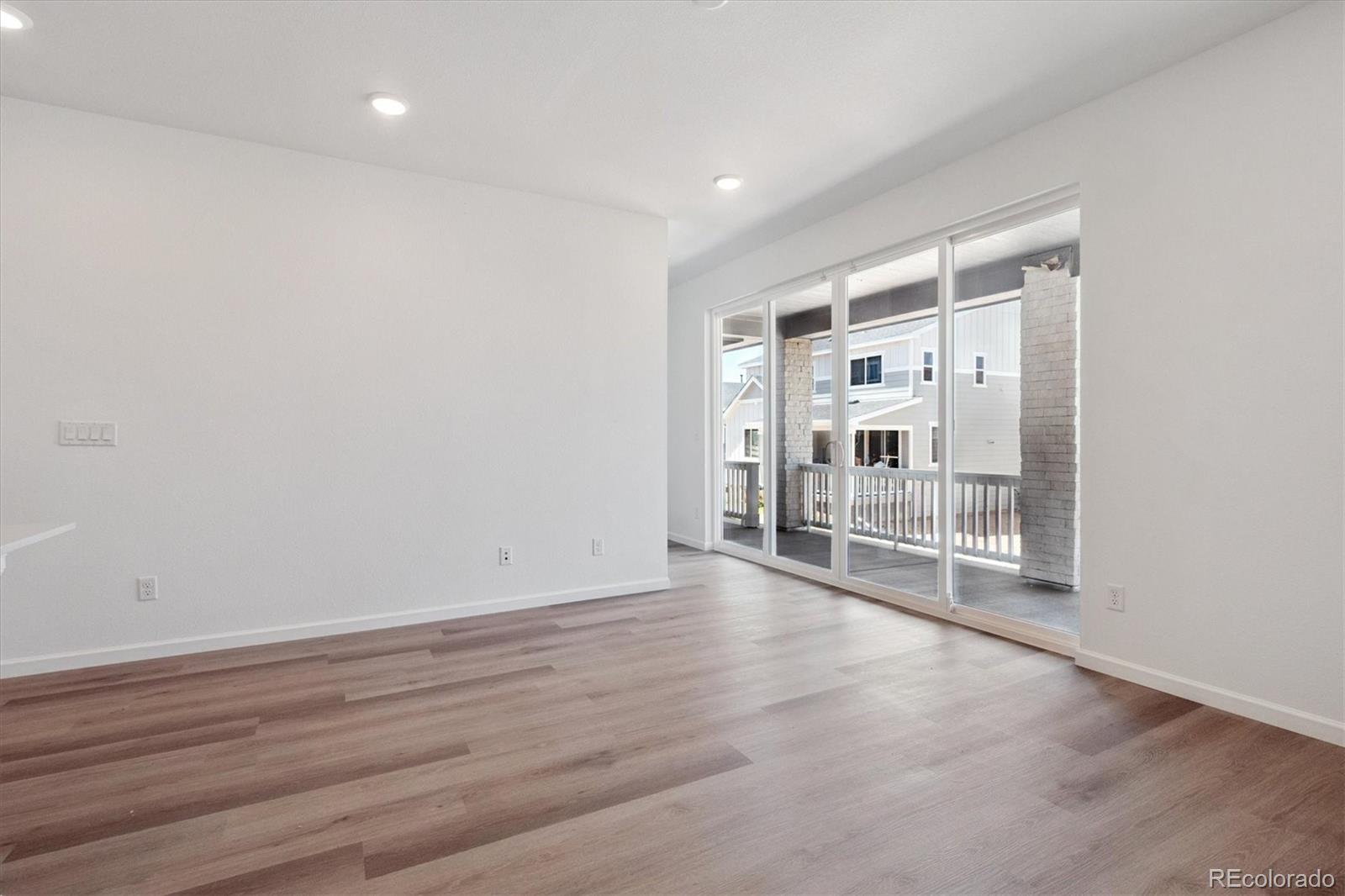 8317 Eagle River Street Littleton, CO 80125 - Photo 7 of 18 a view of empty room with wooden floor