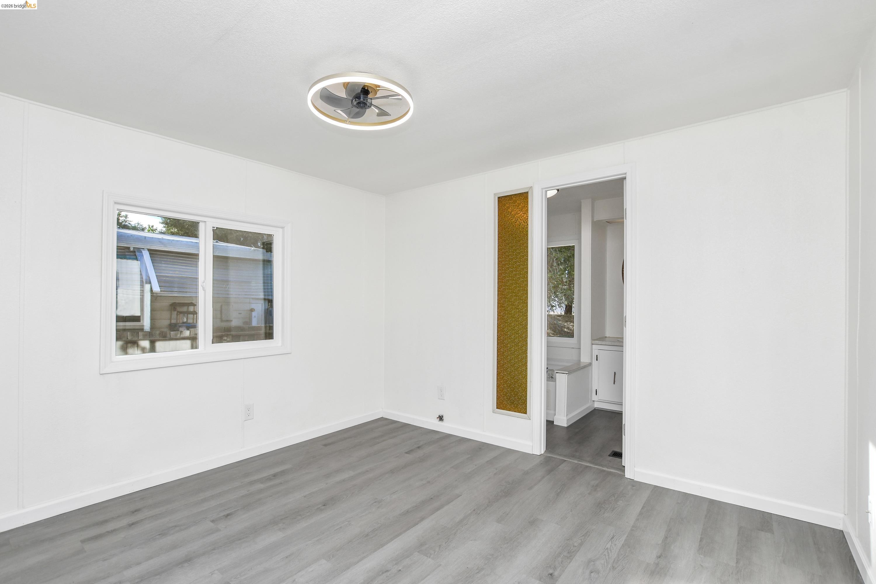 14 Del Rio Pittsburg, CA 94565 - Photo 12 of 25 Primary bedroom with fresh paint, updated dual-pane windows, and laminate flooring.