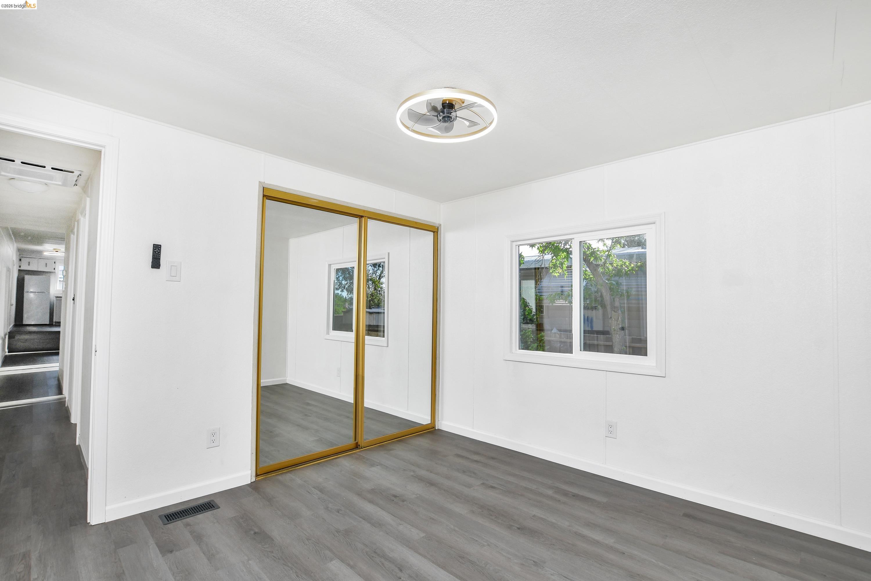 14 Del Rio Pittsburg, CA 94565 - Photo 13 of 25 Primary bedroom with fresh paint, updated dual-pane windows, and laminate flooring.