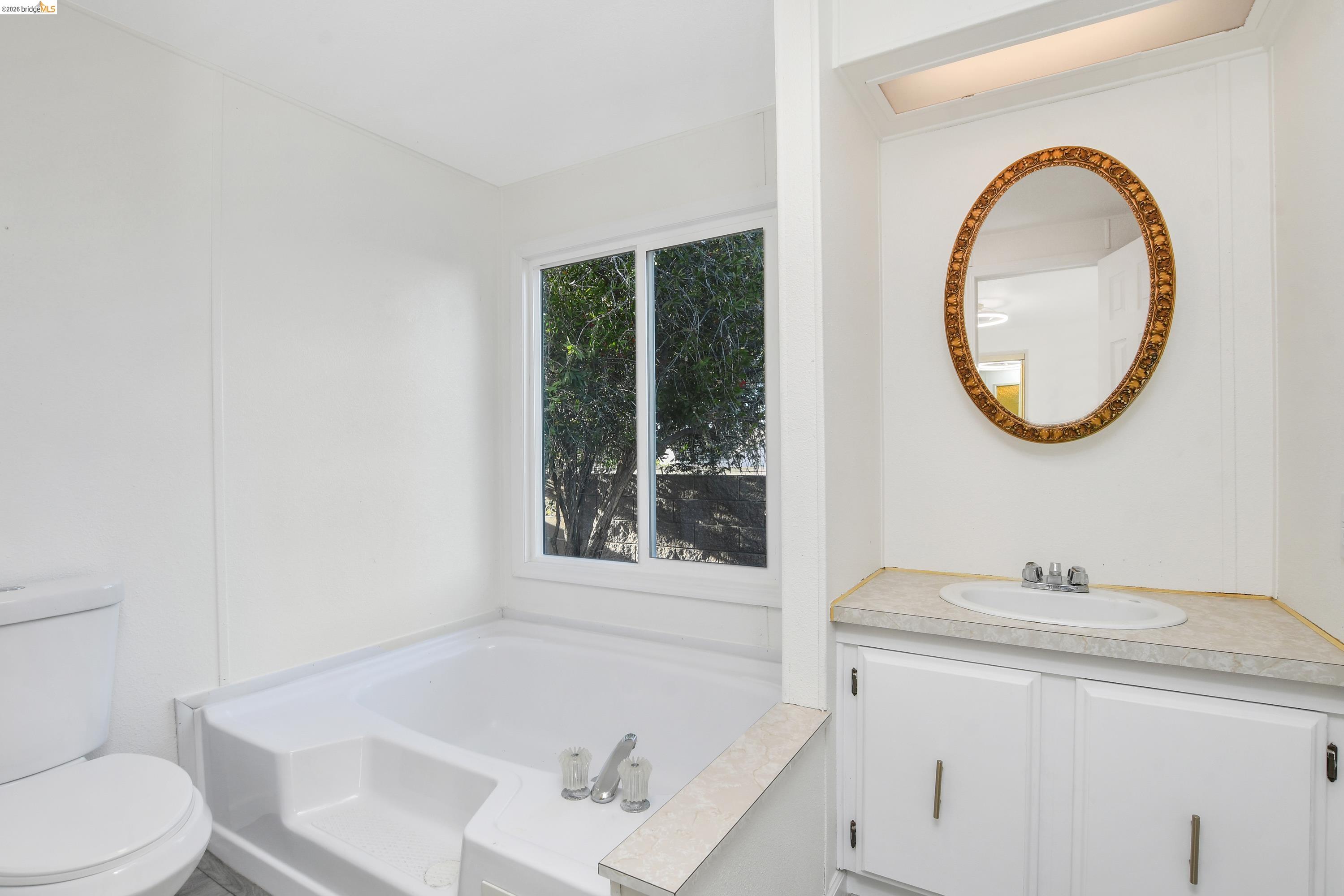 14 Del Rio Pittsburg, CA 94565 - Photo 14 of 25 Light and bright primary bathroom with vanity, soaking tub, and separate stall shower