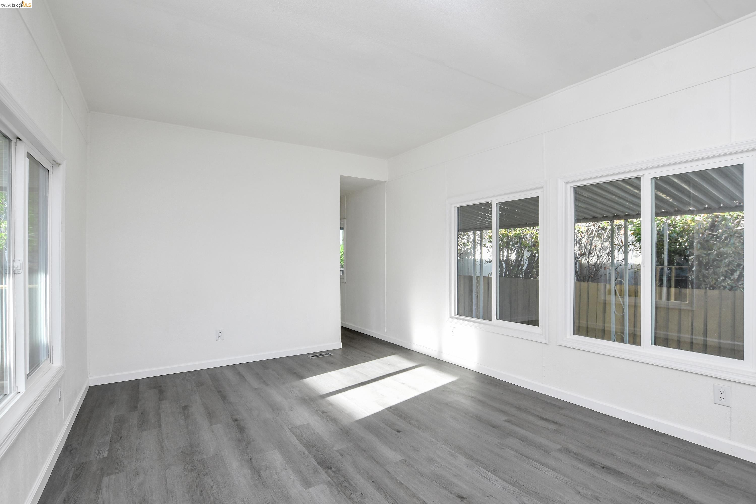 14 Del Rio Pittsburg, CA 94565 - Photo 3 of 25 Living room with fresh paint, updated dual-pane windows, and laminate flooring