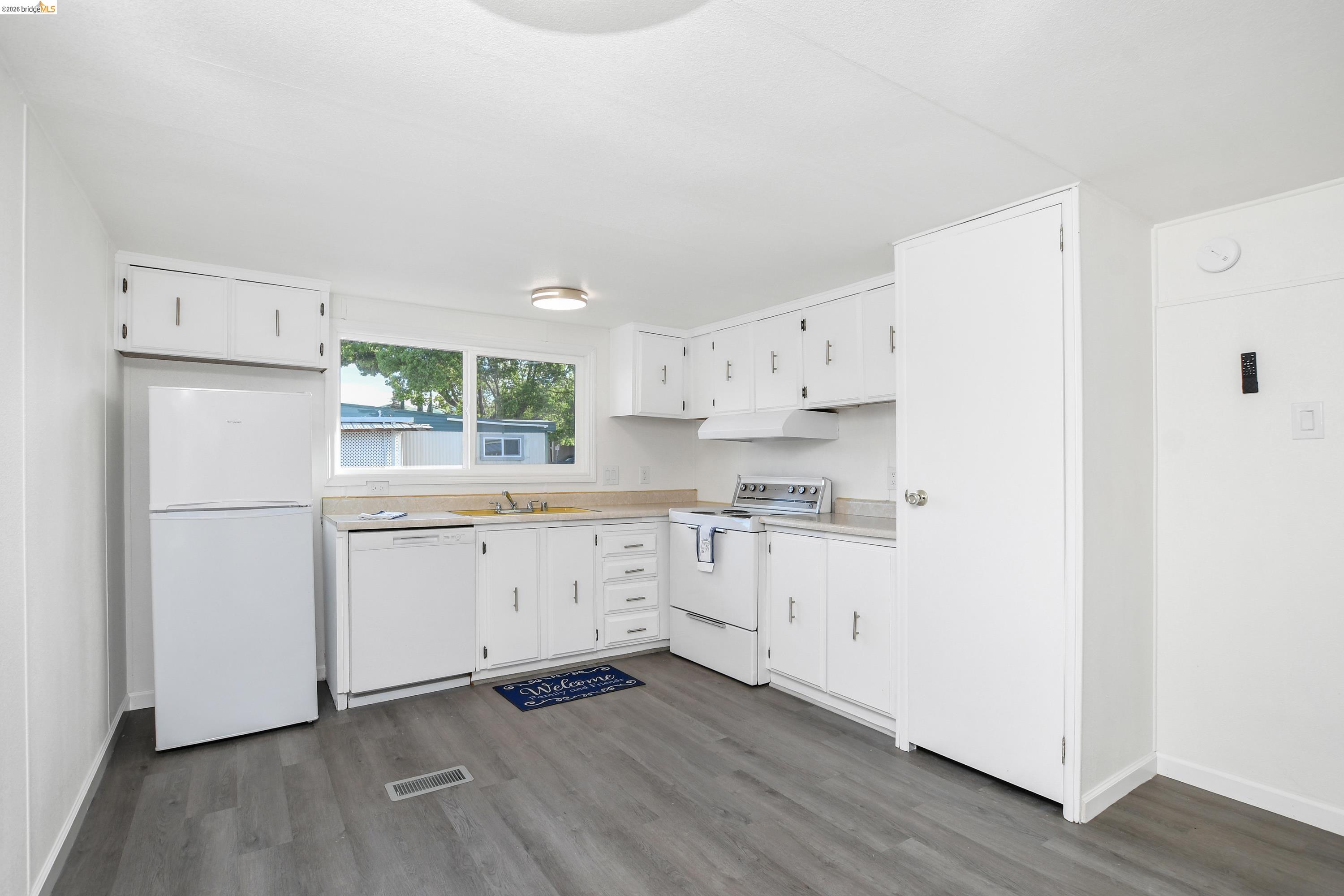 14 Del Rio Pittsburg, CA 94565 - Photo 5 of 25 Bright kitchen with ample cabinet space, laminate countertops, and dining area
