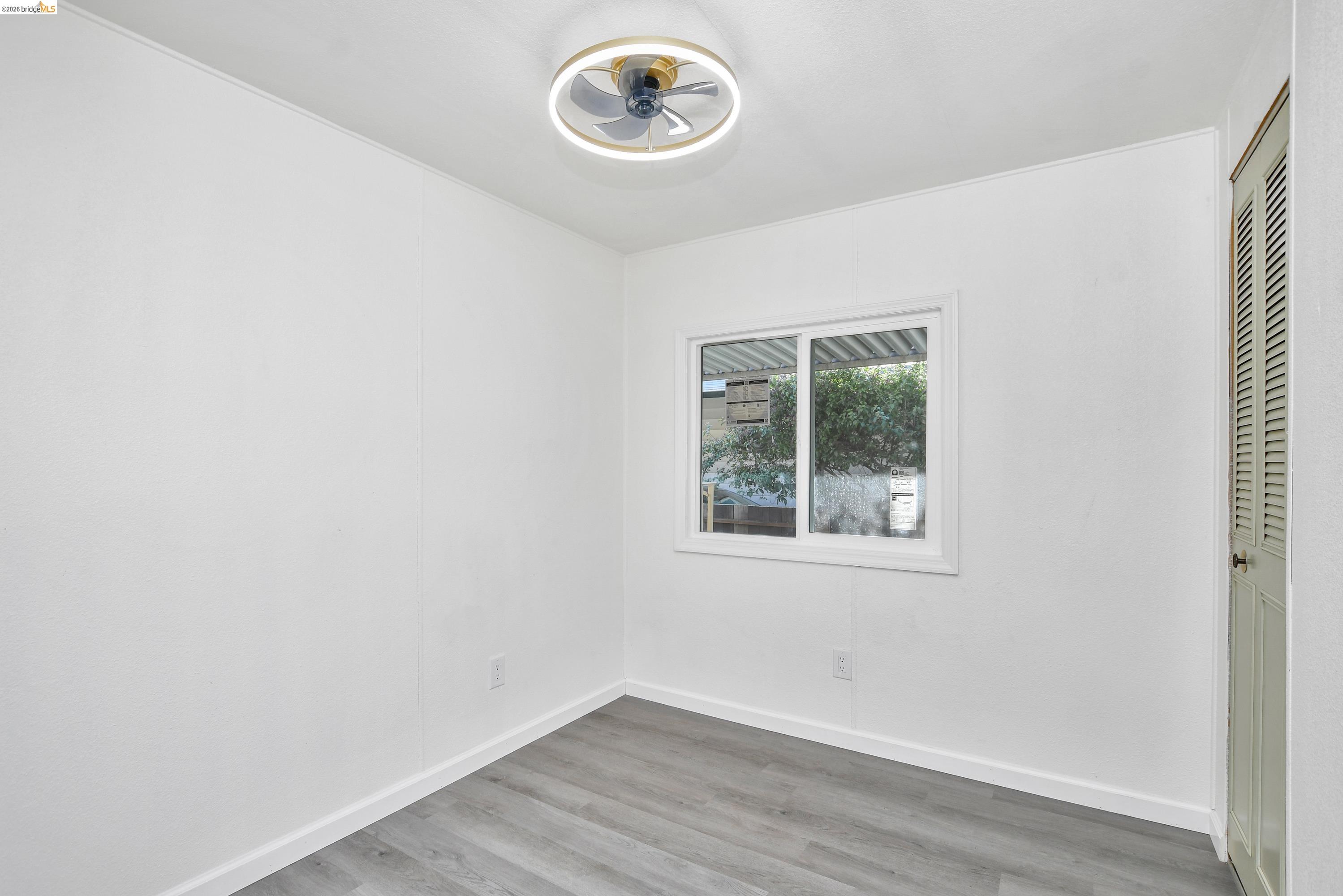 14 Del Rio Pittsburg, CA 94565 - Photo 8 of 25 Bedroom featuring fresh paint, updated dual-pane windows, and laminate flooring