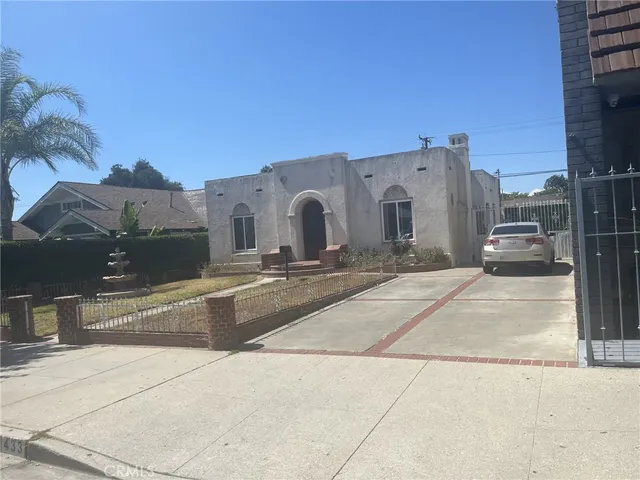 a large parking space with a large tree in front of it