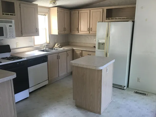 a kitchen with a sink stove and refrigerator