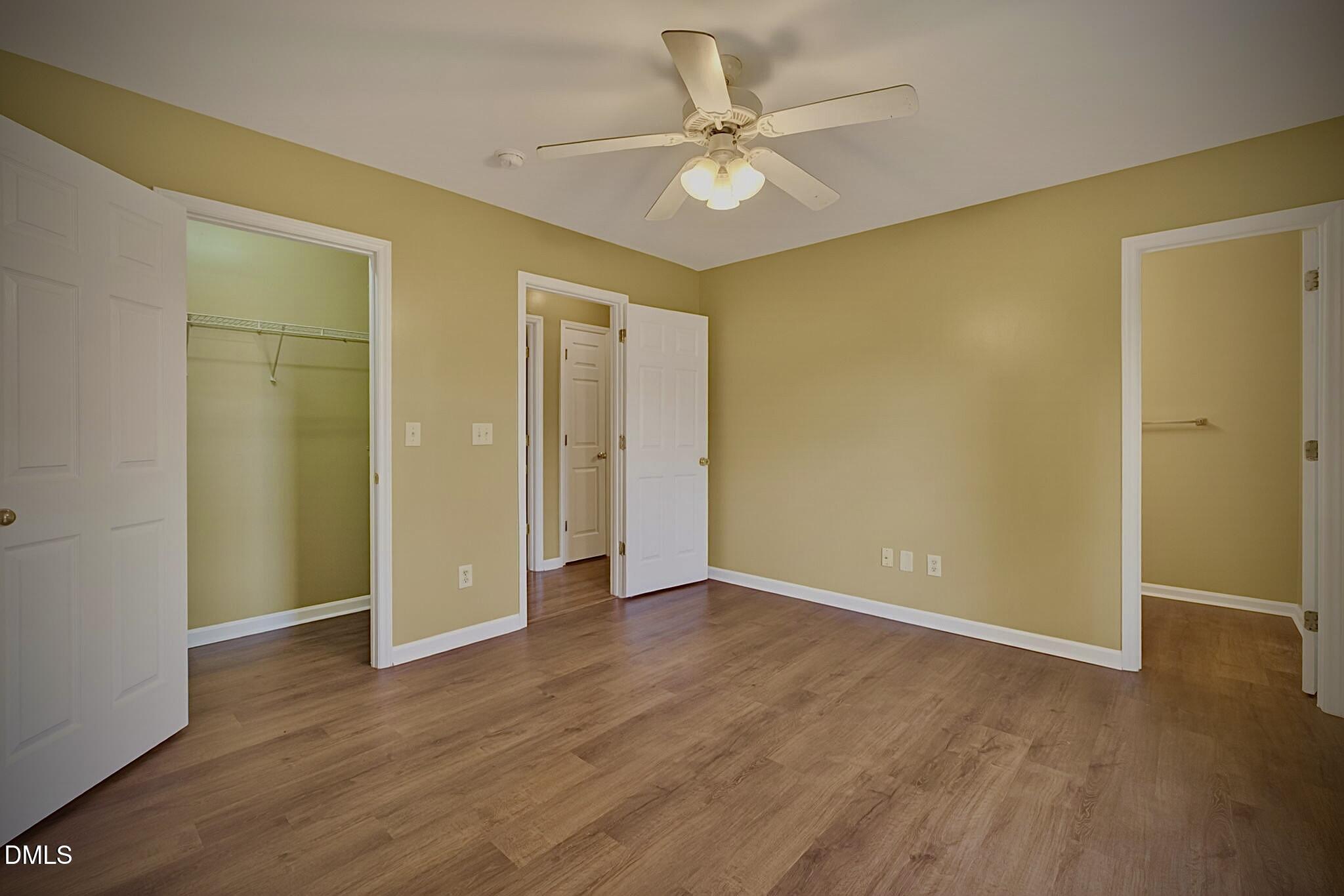 5415 Gunnette Drive Raleigh, NC 27610 - Photo 11 of 37 an empty room with wooden floor and a ceiling fan