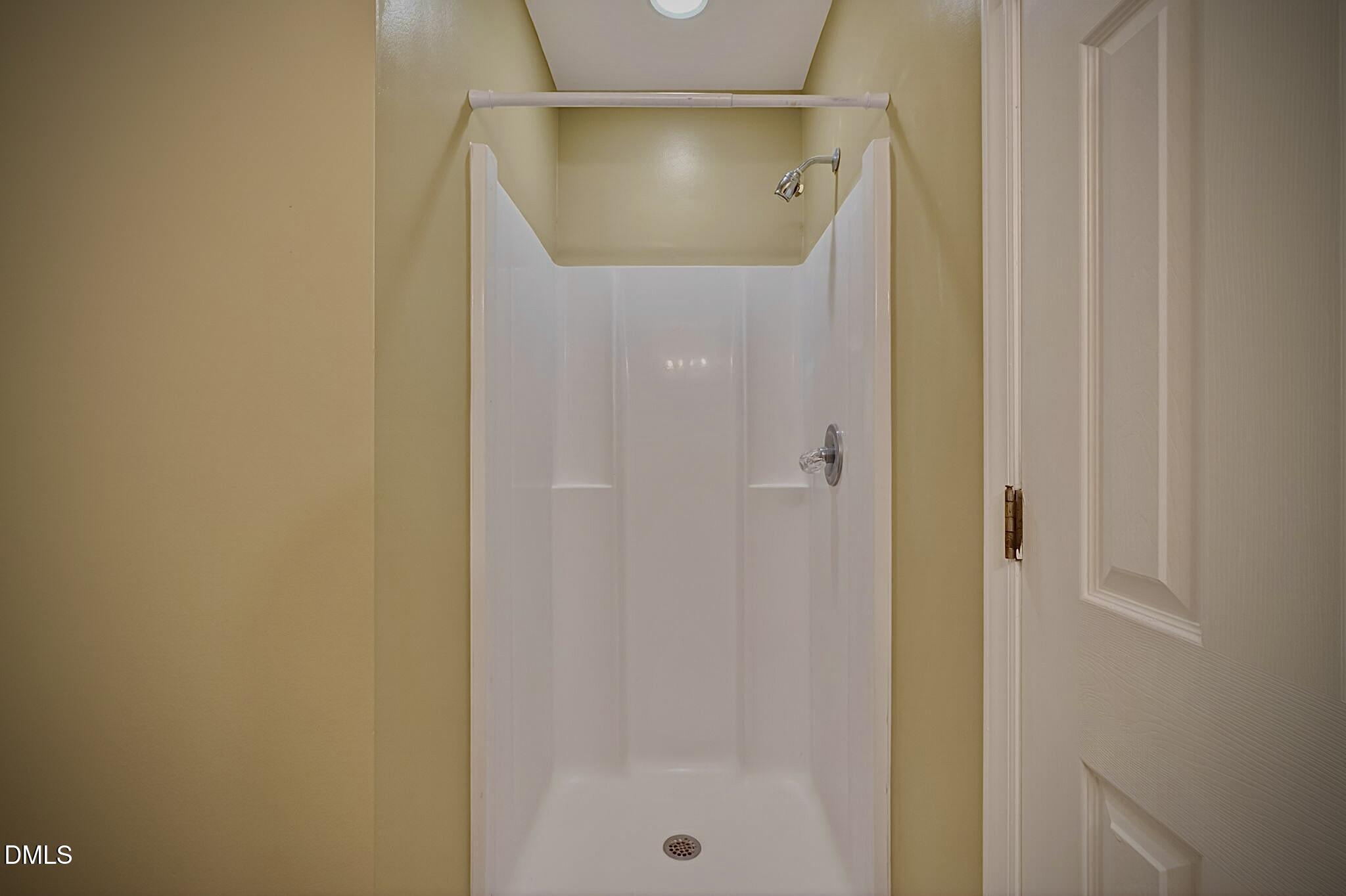 5415 Gunnette Drive Raleigh, NC 27610 - Photo 14 of 37 a bathroom with a glass shower door