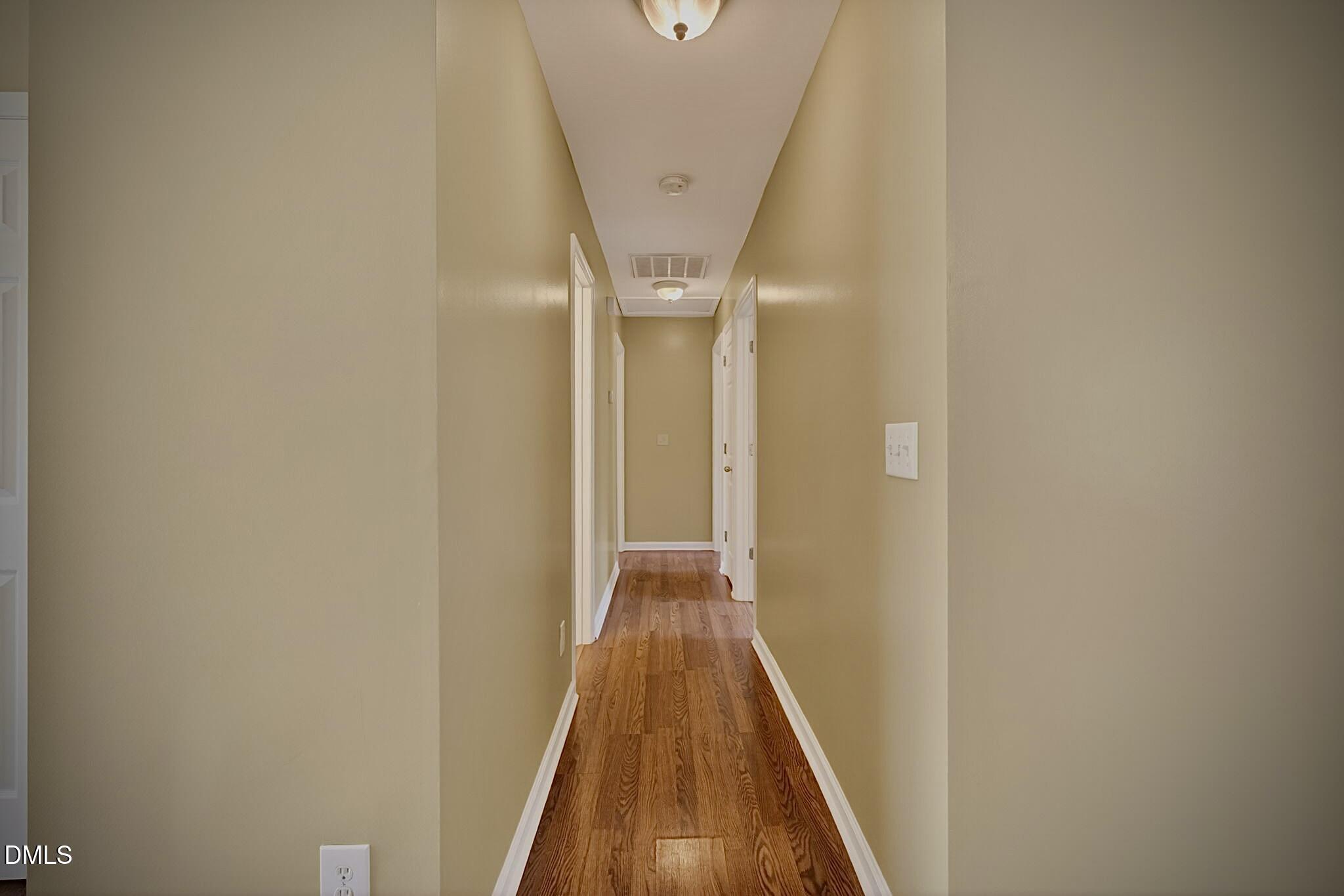 5415 Gunnette Drive Raleigh, NC 27610 - Photo 20 of 37 a view of a hallway with wooden floor