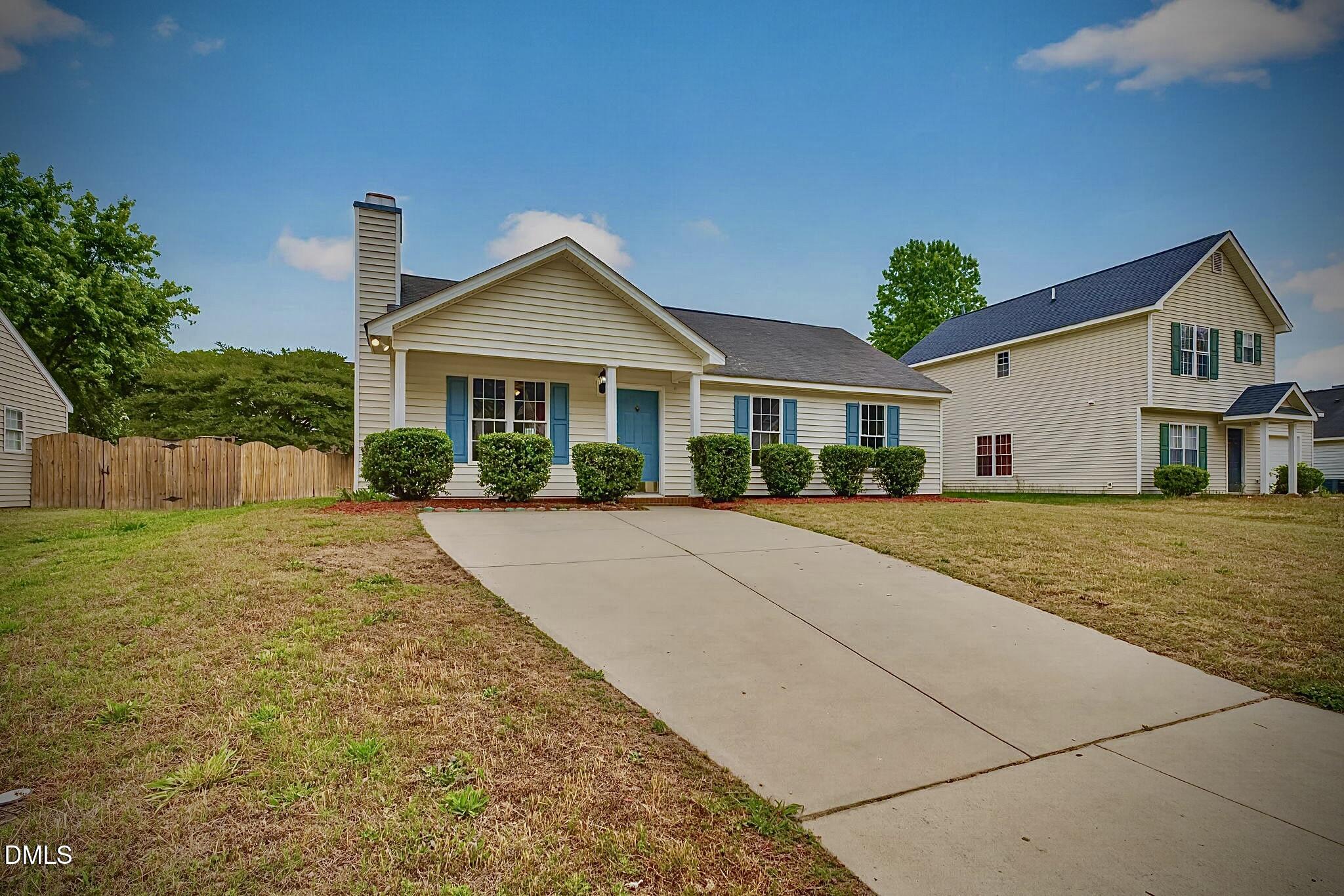 5415 Gunnette Drive Raleigh, NC 27610 - Photo 2 of 37 a front view of a house with a yard and potted plants