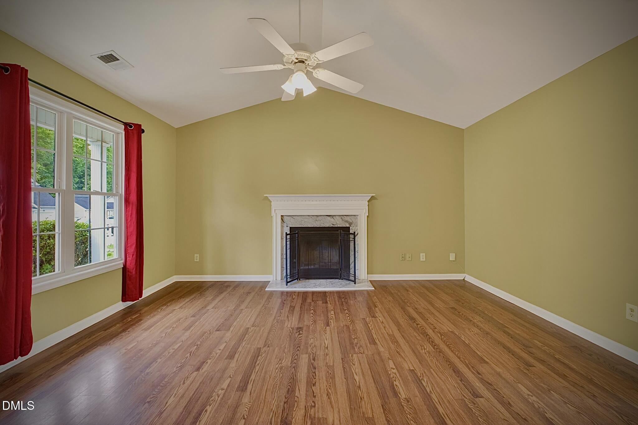 5415 Gunnette Drive Raleigh, NC 27610 - Photo 21 of 37 a view of an empty room with a window and wooden floor