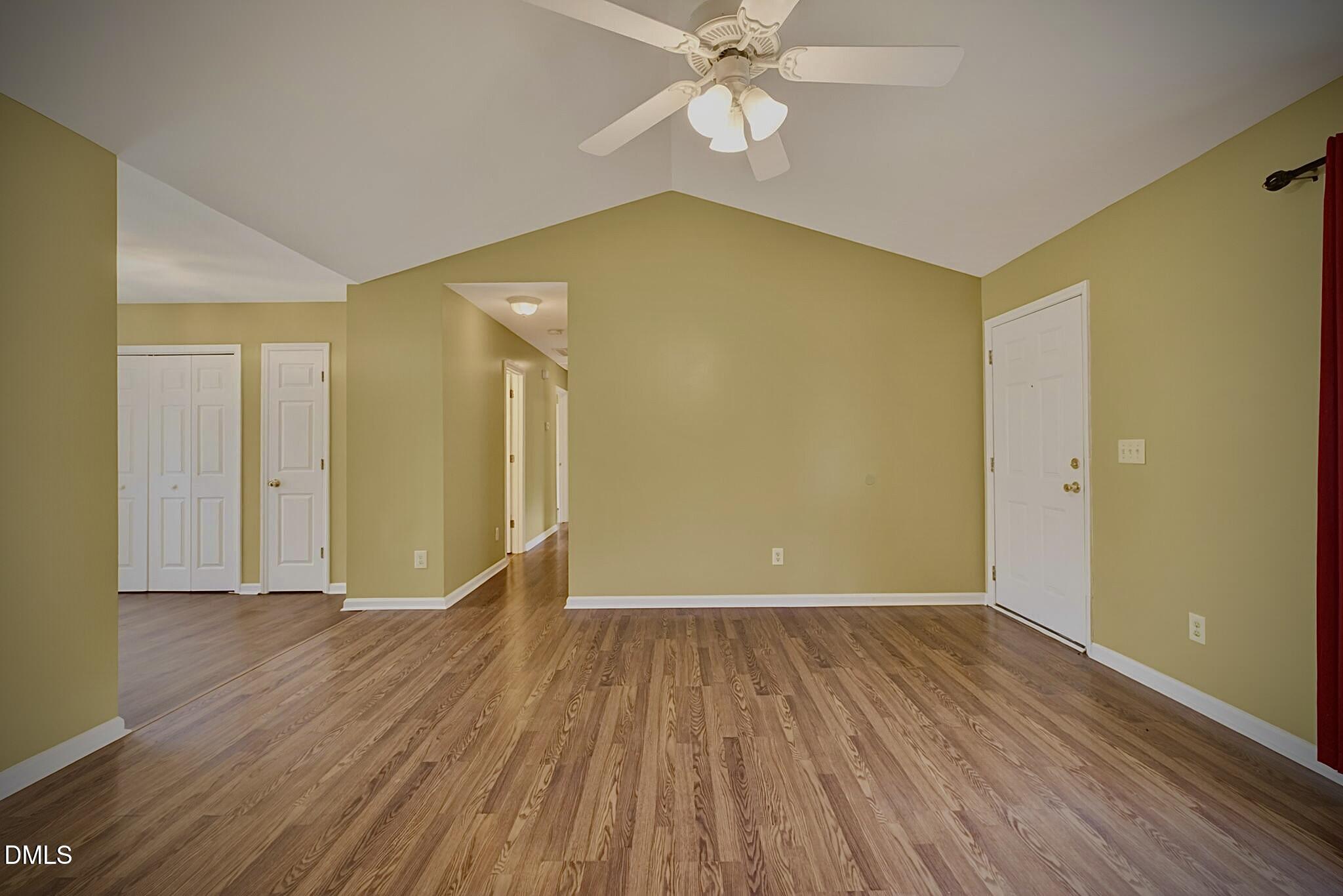 5415 Gunnette Drive Raleigh, NC 27610 - Photo 22 of 37 a view of a big room with wooden floor and a ceiling fan