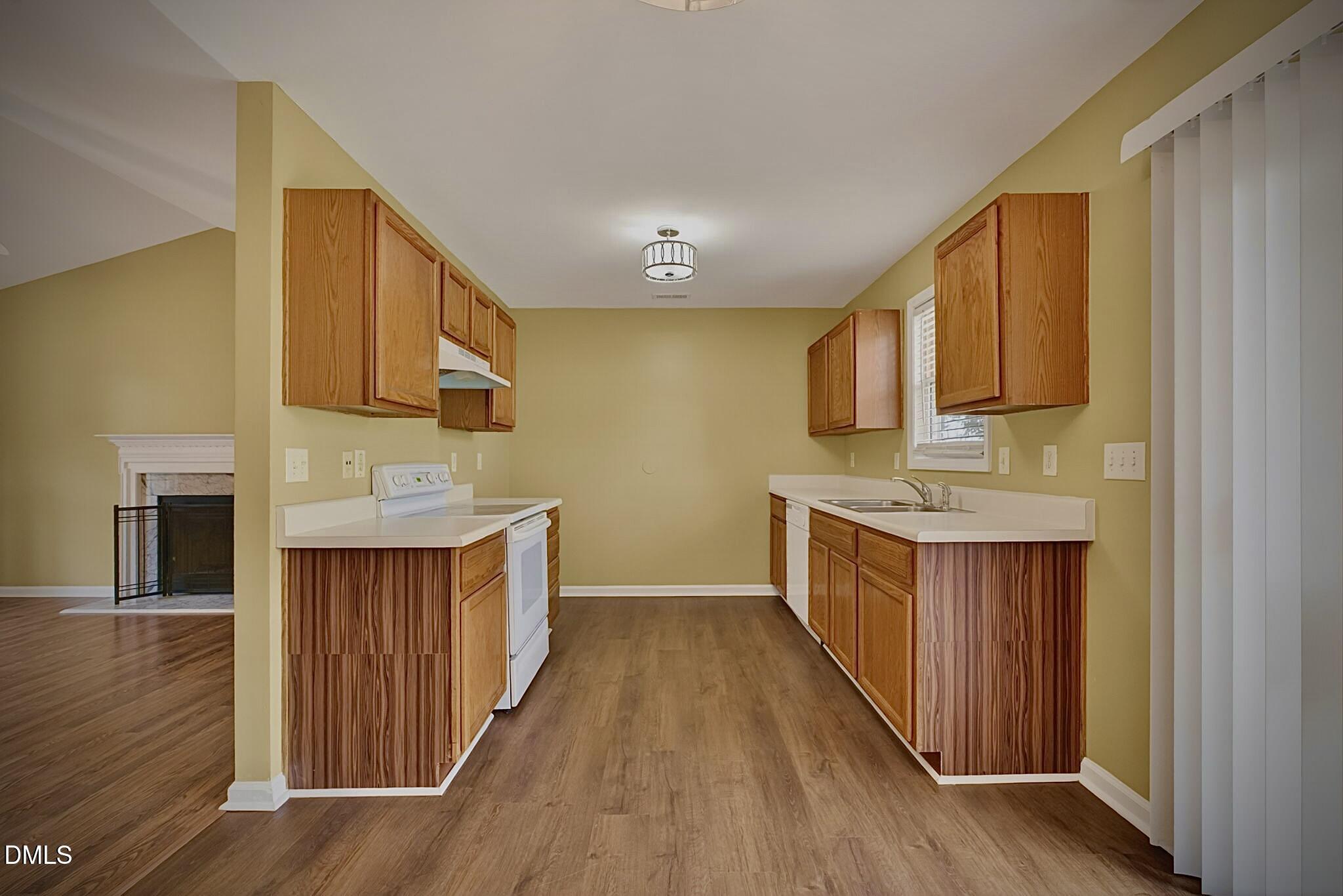 5415 Gunnette Drive Raleigh, NC 27610 - Photo 23 of 37 a kitchen with stainless steel appliances a sink cabinets and wooden floor