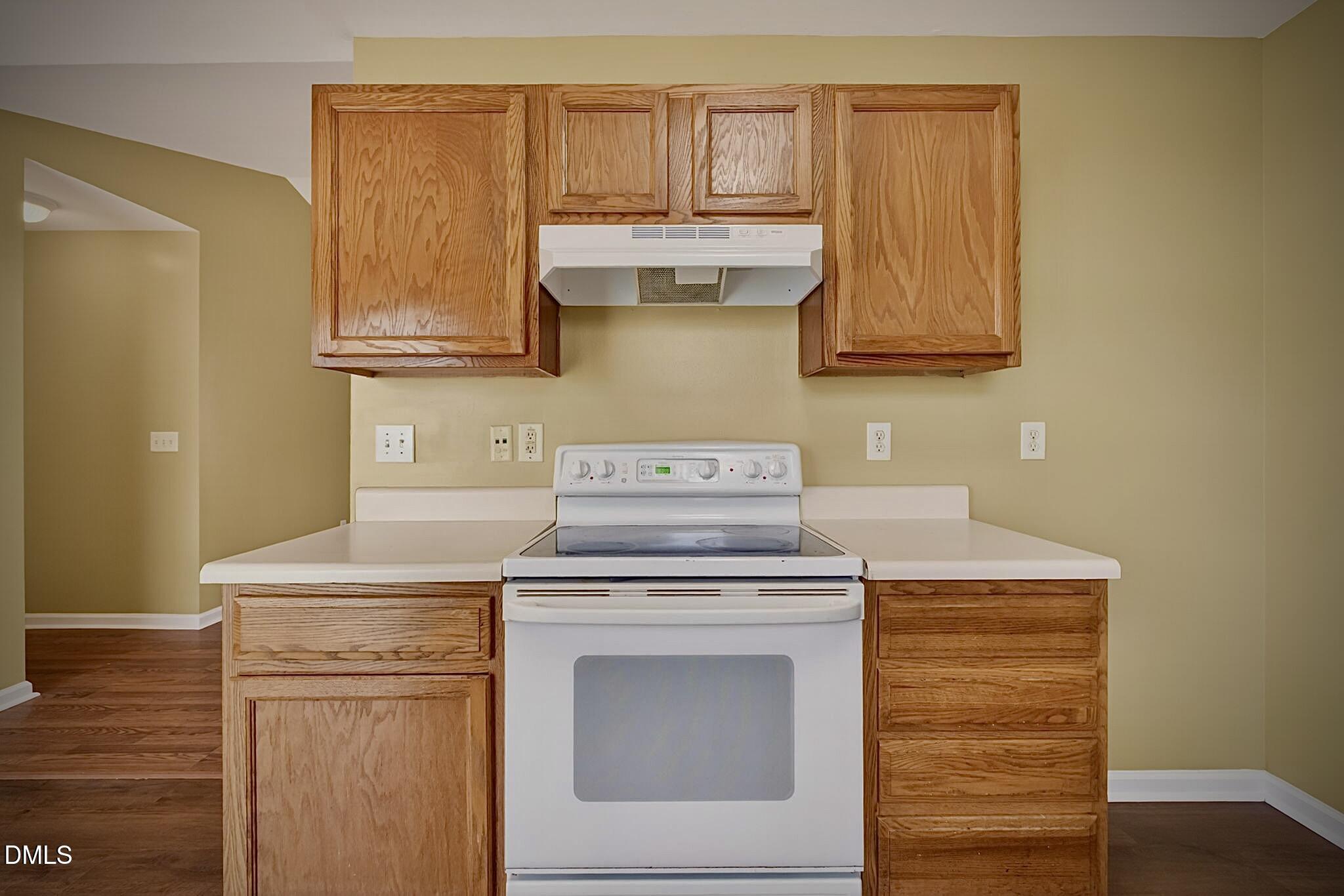 5415 Gunnette Drive Raleigh, NC 27610 - Photo 29 of 37 a kitchen with granite countertop cabinets stainless steel appliances and a wooden floor