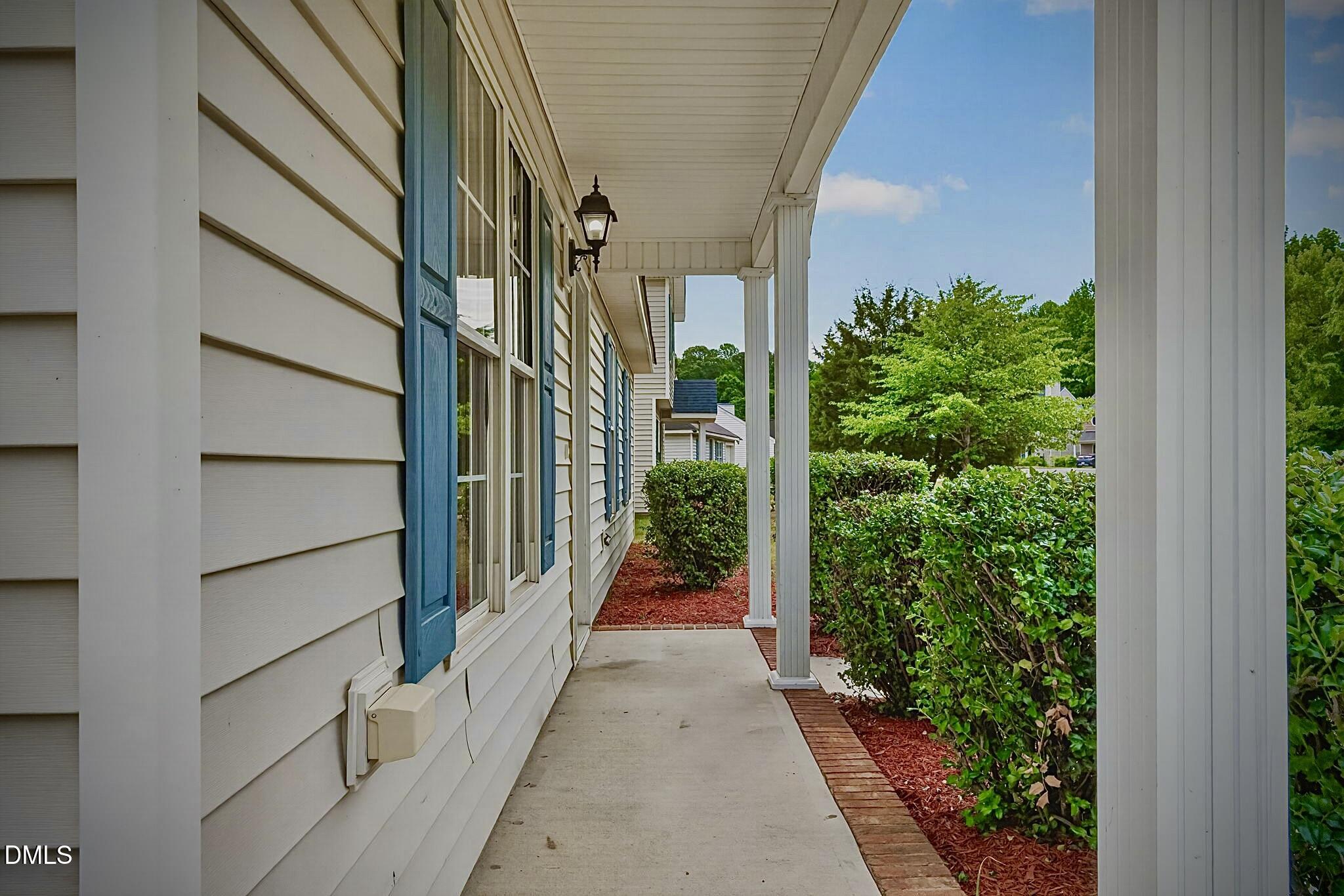 5415 Gunnette Drive Raleigh, NC 27610 - Photo 4 of 37 a view of a pathway of a house with flower plants