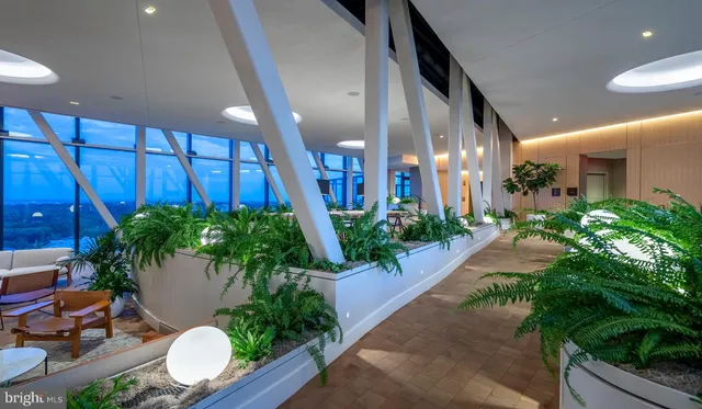 a balcony with furniture and a potted plant