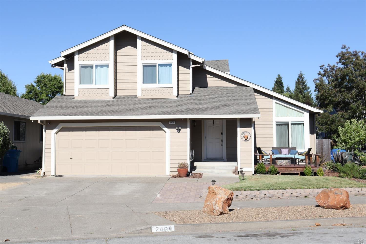 2408 Pinercrest Drive Santa Rosa, CA 95403 - Photo 1 of 1 a front view of a house with a yard and garage