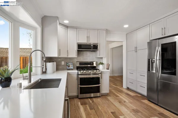 a hallway with a large window and a couch