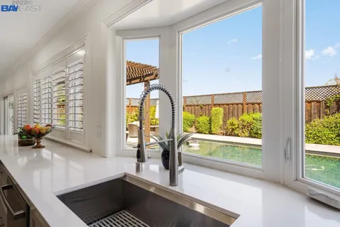 a hallway with a large window and a couch