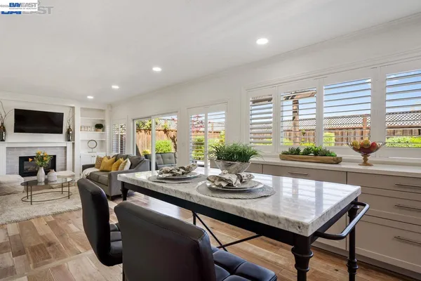 a kitchen with stainless steel appliances kitchen island hardwood floor sink and stove