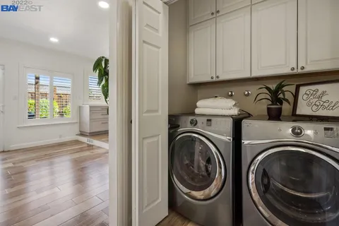 a view of a hallway with washer and dryer