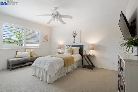 a bedroom with bed and a flat screen tv