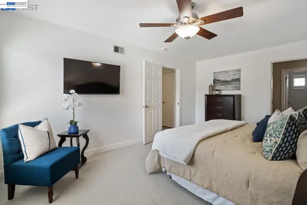 a bedroom with a bed and a couch