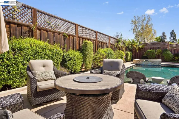 a view of a patio with couches table and chairs and potted plants