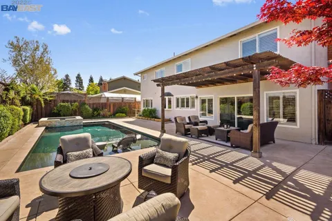 a view of a patio with couches table and chairs and potted plants