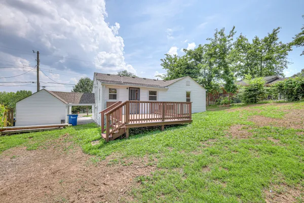 a view of a house with yard and a garden